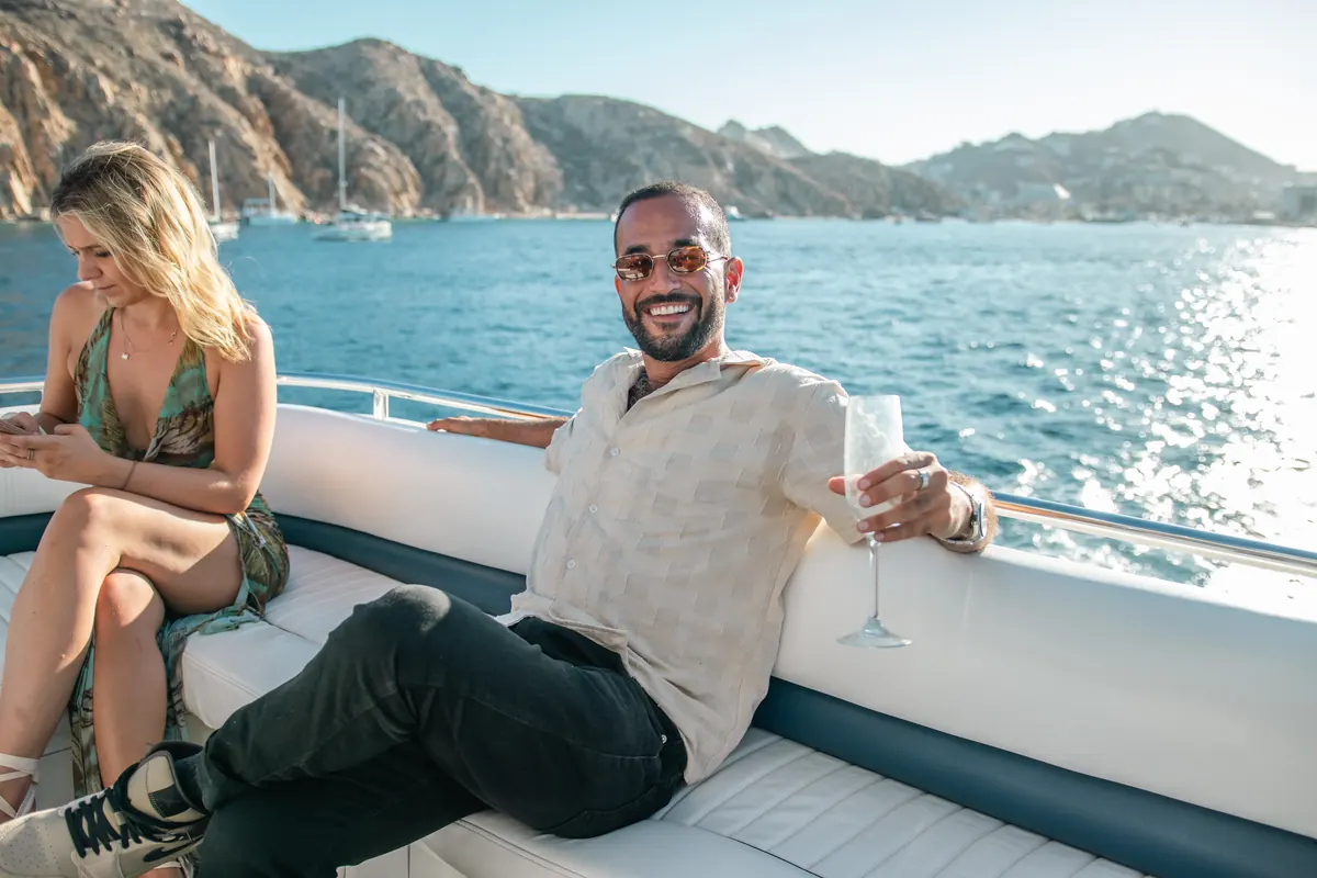 Couple lounging on the party yacht in Cabo San Lucas